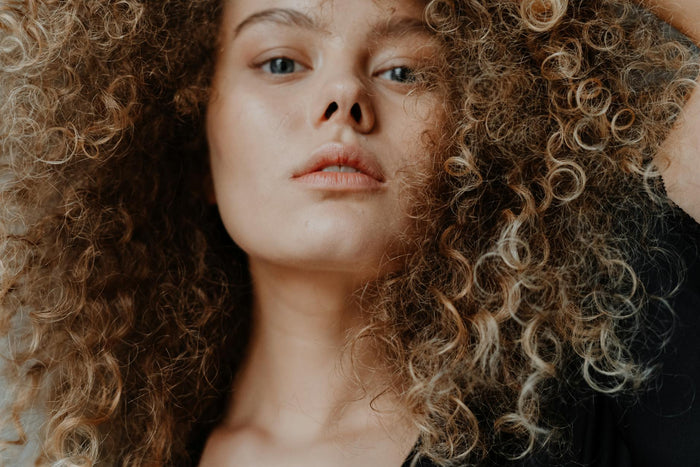 Close-up of natural curly hair texture and frizz