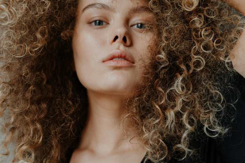 Close-up of natural curly hair texture and frizz