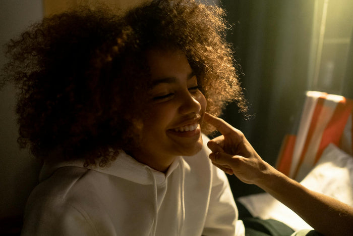 Woman with refreshed second-day curly hair smiling